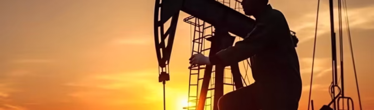 worker-and-oil-rig-in-sunset
